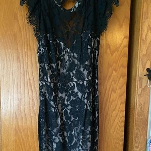 Black and nude lace dress with open back.